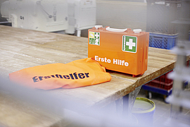 Verbandkasten und Ersthelferjacke auf einem Backtisch
