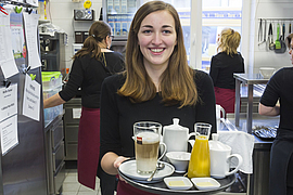 Servicekraft mit Getränke auf einem Tablett im Hotel Bartmann's Haus Dillenburg